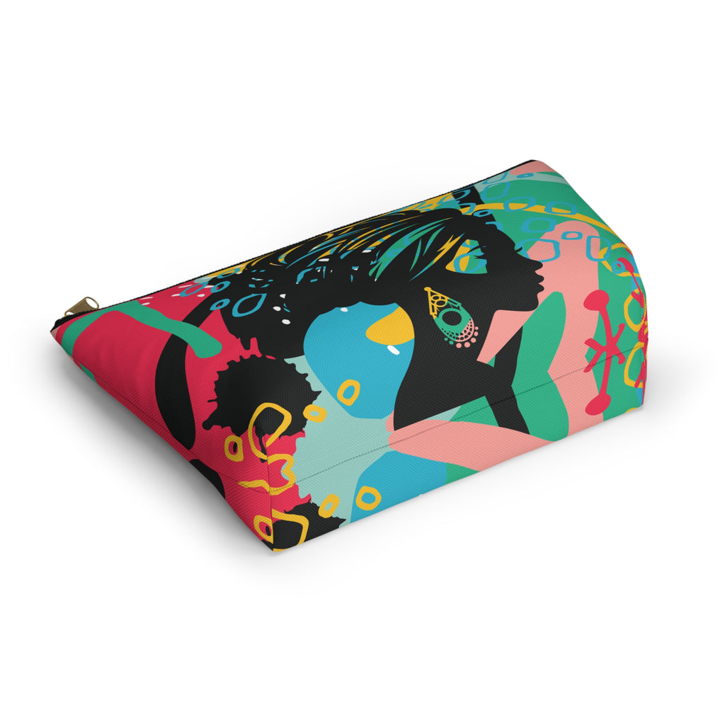 A rectangular zippered pouch with a vibrant, multicolored abstract pattern featuring stylized female silhouettes in black, pink, teal, and blue, shown on a clean white background.